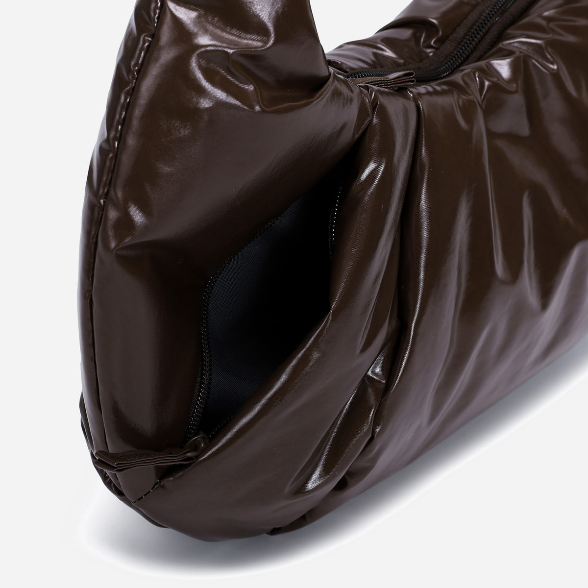 A glossy texture Croissant-shaped shoulder bag in glossy brown color by Dude & Bestie