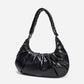 A black shiny Croissant-shaped shoulder bag with a single strap in polish black color
