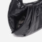 A black shiny Croissant-shaped shoulder bag with a single strap in polish black color