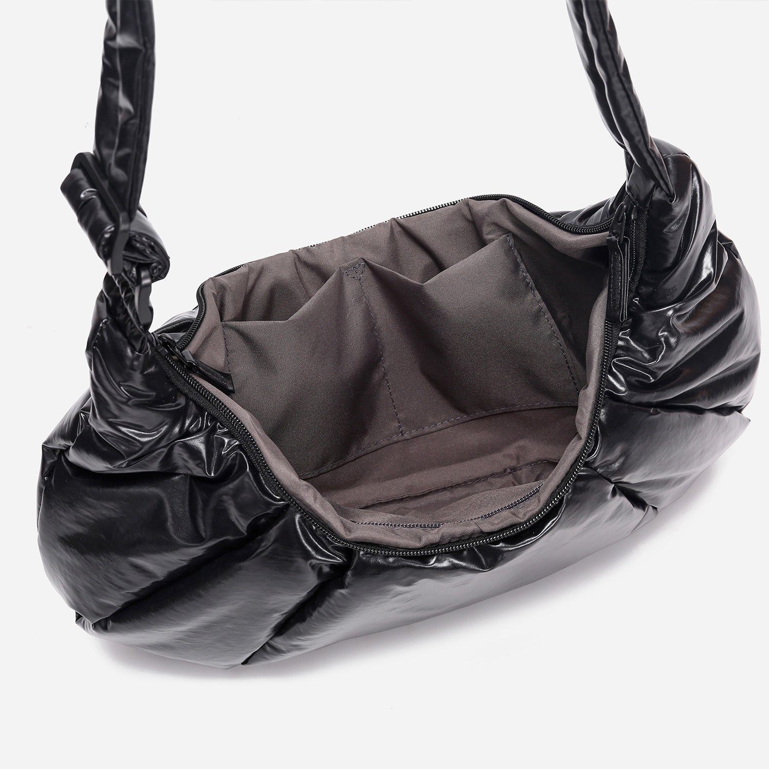 A black shiny Croissant-shaped shoulder bag with a single strap in polish black color