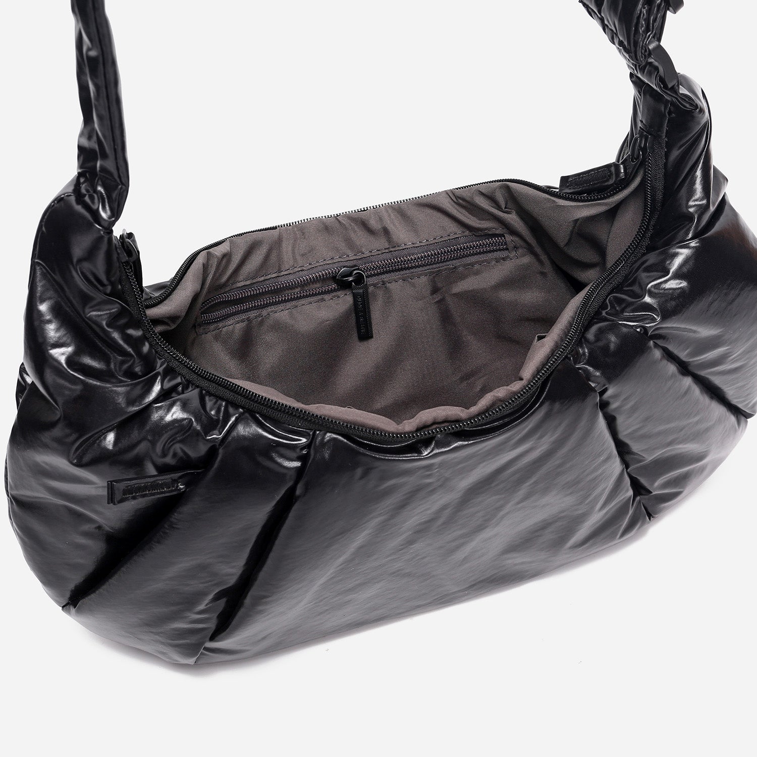 A black shiny Croissant-shaped shoulder bag with a single strap in polish black color
