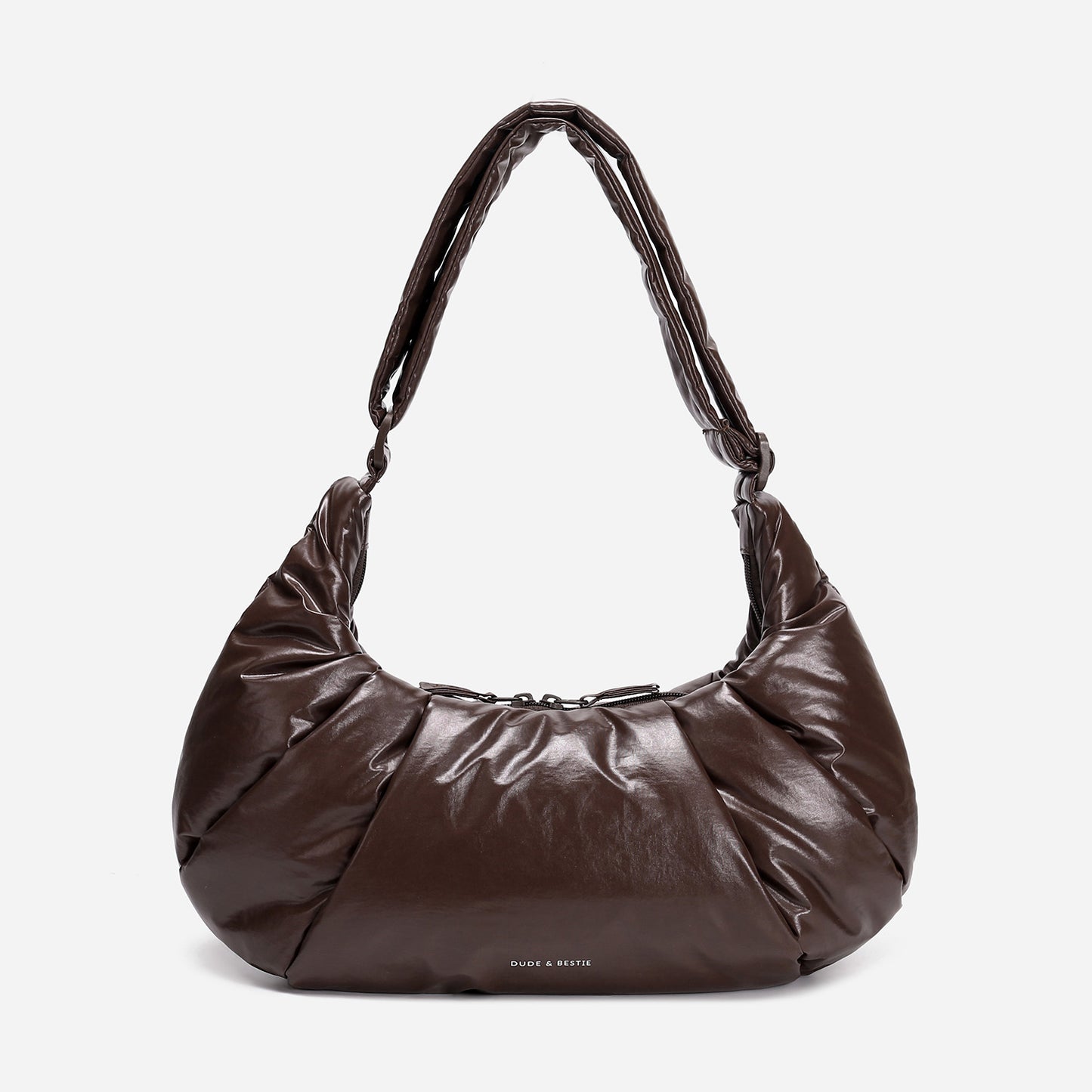 A dark brown shiny Croissant-shaped shoulder bag in polish brown color by Dude & Bestie
