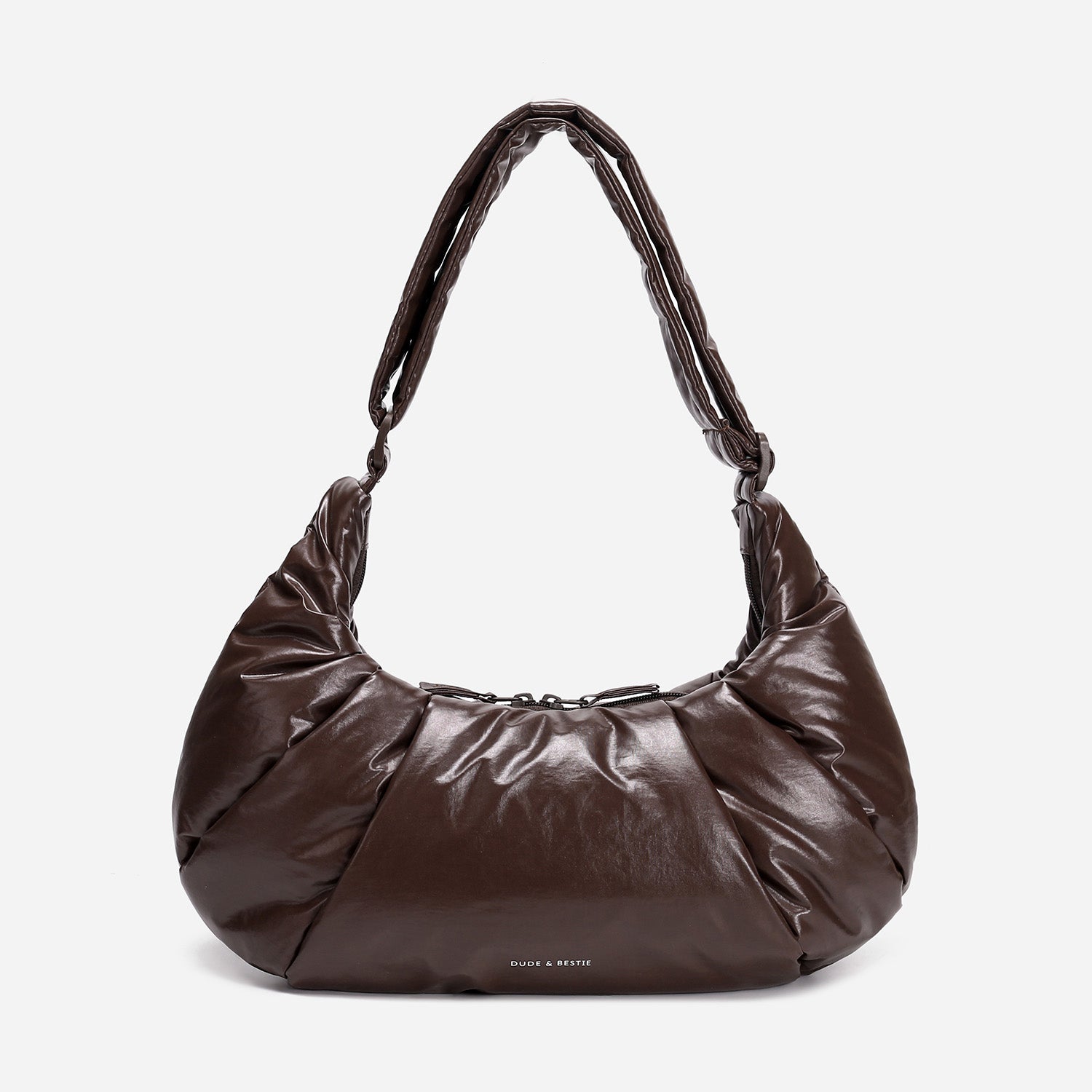 A dark brown shiny Croissant-shaped shoulder bag in polish brown color by Dude & Bestie
