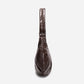 A dark brown shiny Croissant-shaped shoulder bag in polish brown color by Dude & Bestie