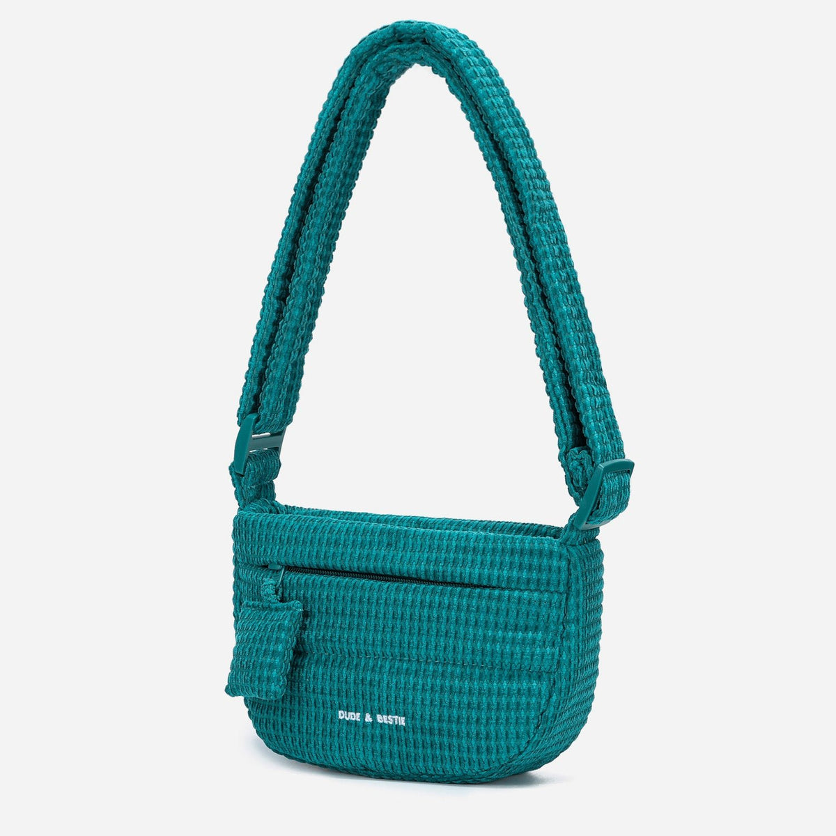 A teal woven corduroy shoulder bag by Dude & Bestie Winter 2026 Series